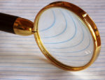 Magnifying glass on lined paper