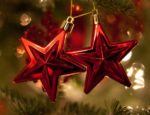 Red star ornaments on Christmas tree