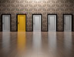 A photo of seven hallway doors, six white and one yellow. The photo represents possibilities for 2019.