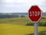 Stop sign near open field